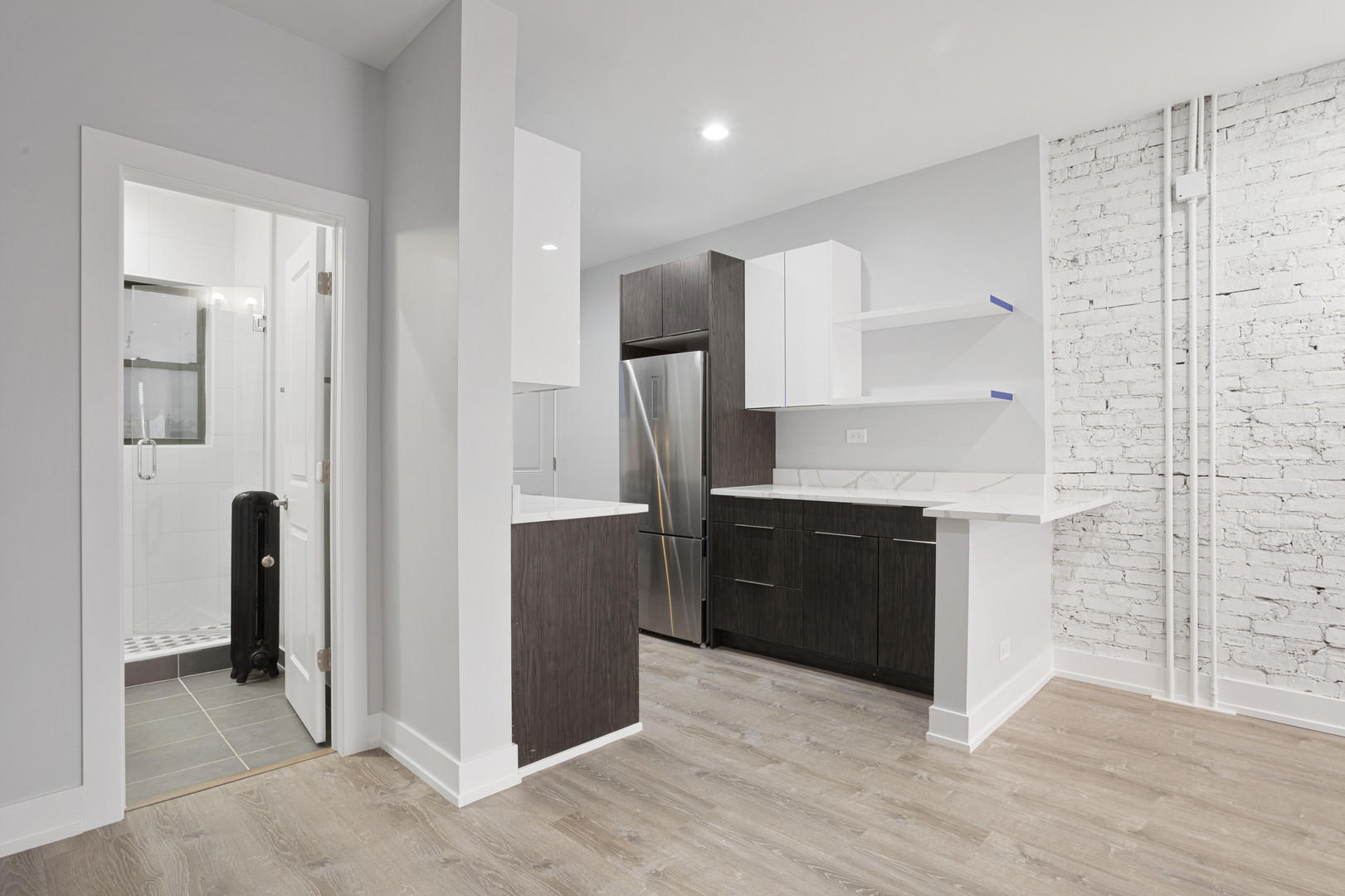 1708 West Juneway Terrace, Unit 2J Chicago, IL 60626 - Photo 3 of 13 a kitchen with stainless steel appliances granite countertop a refrigerator and a sink