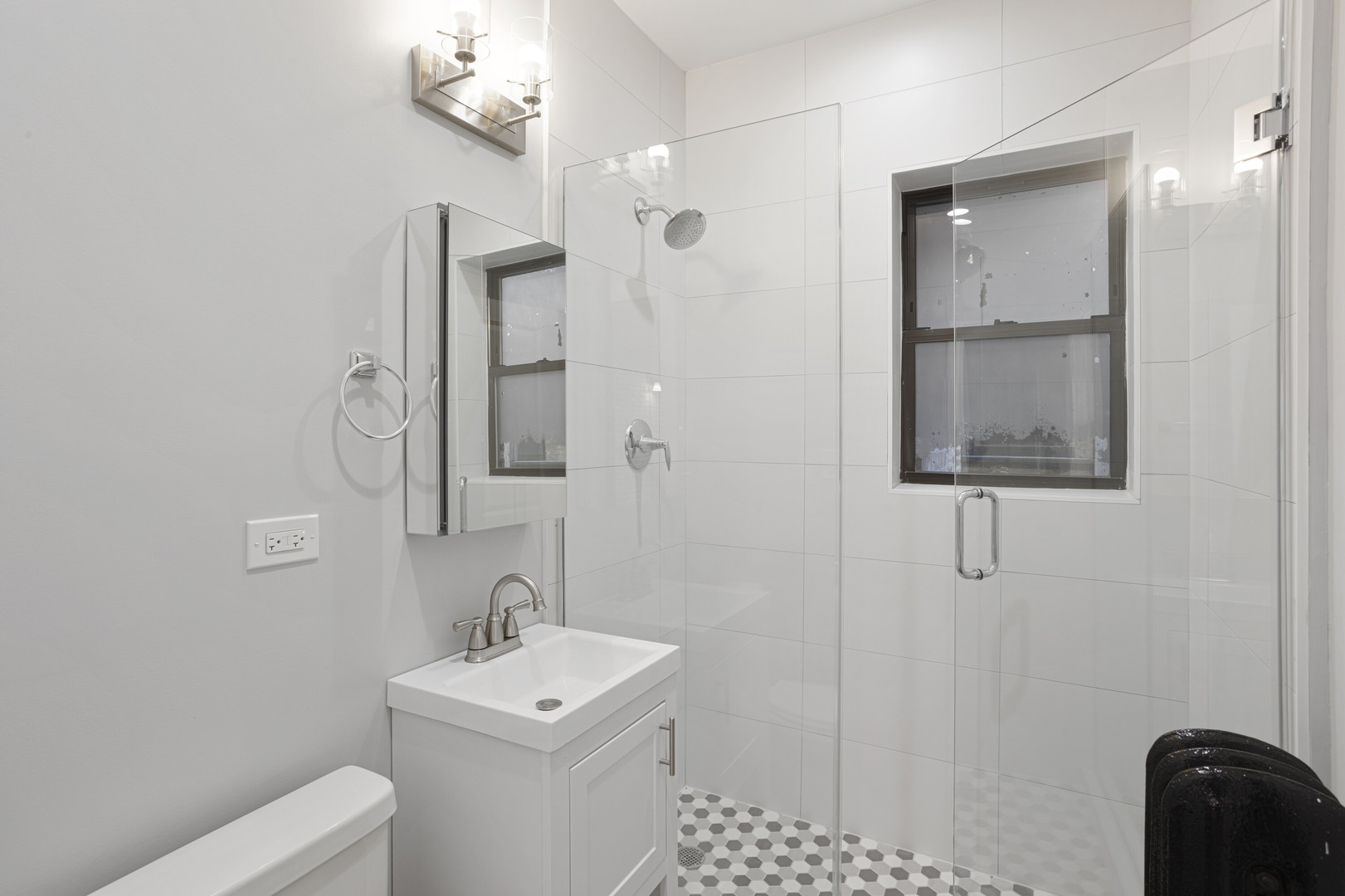 1708 West Juneway Terrace, Unit 2J Chicago, IL 60626 - Photo 9 of 13 a bathroom with a toilet a sink a mirror a vanity and vanity