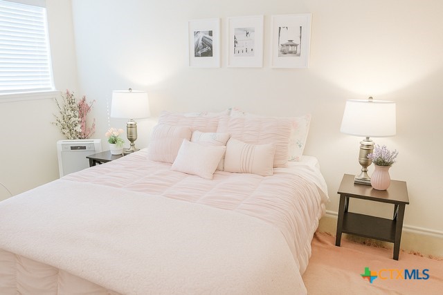 1054 Rolling Path New Braunfels, TX 78130 - Photo 9 of 14 a bedroom with a bed and a lamp on dresser