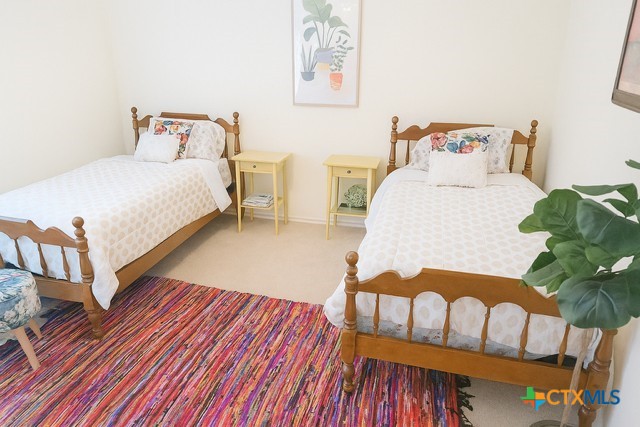 1054 Rolling Path New Braunfels, TX 78130 - Photo 10 of 14 a bedroom with bed and a painting on the wall