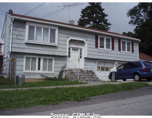 10 Utica Street Milford, CT 06461 - Photo 1 of 1 a front view of a house with a yard and garage