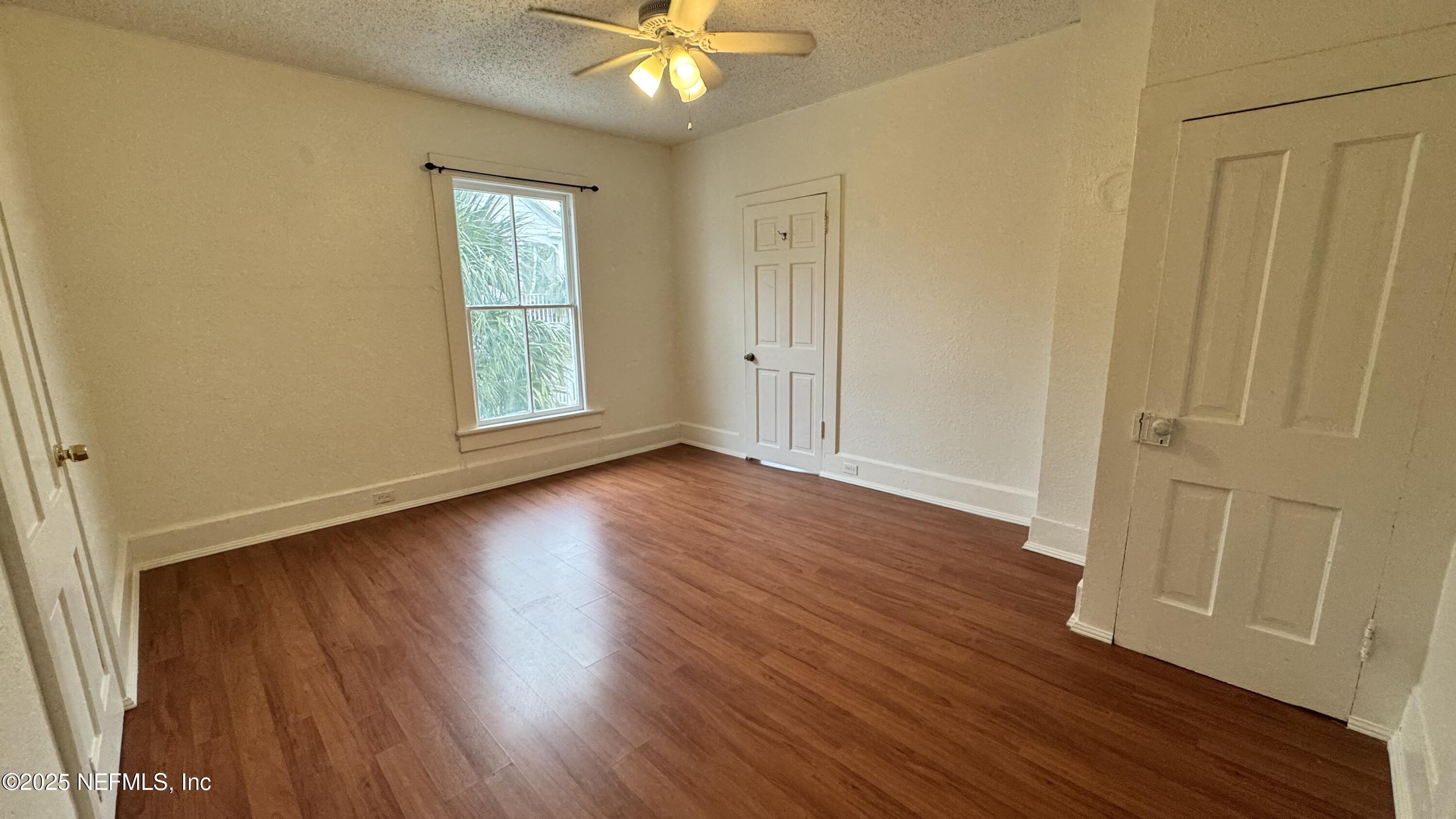 32 Sanford Street St. Augustine, FL 32084 - Photo 11 of 13 an empty room with wooden floor and windows
