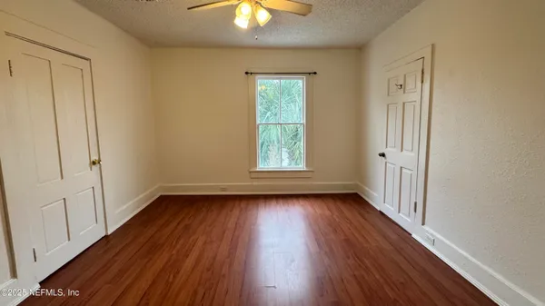 wooden floor in an empty room with a window