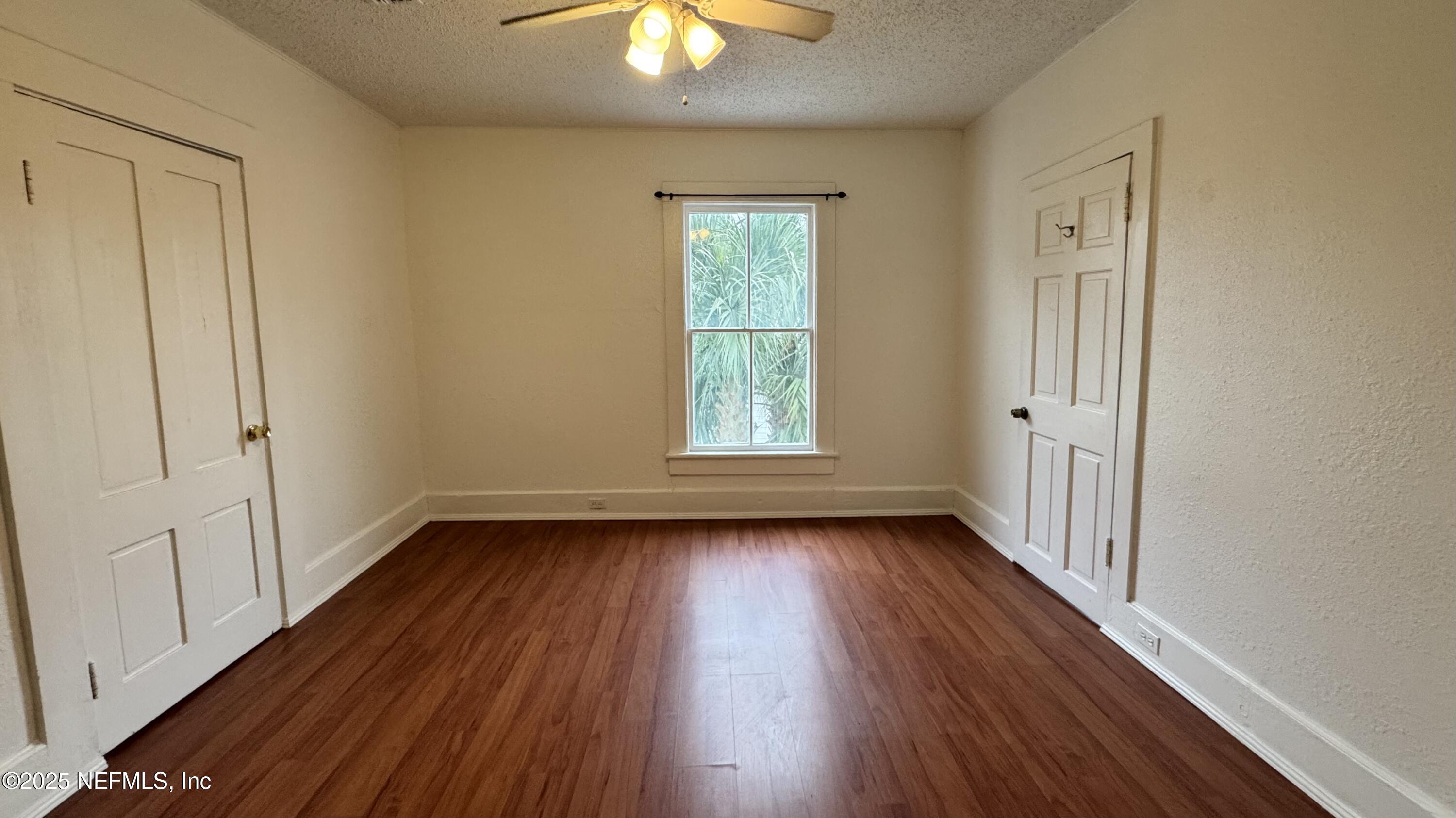32 Sanford Street St. Augustine, FL 32084 - Photo 10 of 13 wooden floor in an empty room with a window