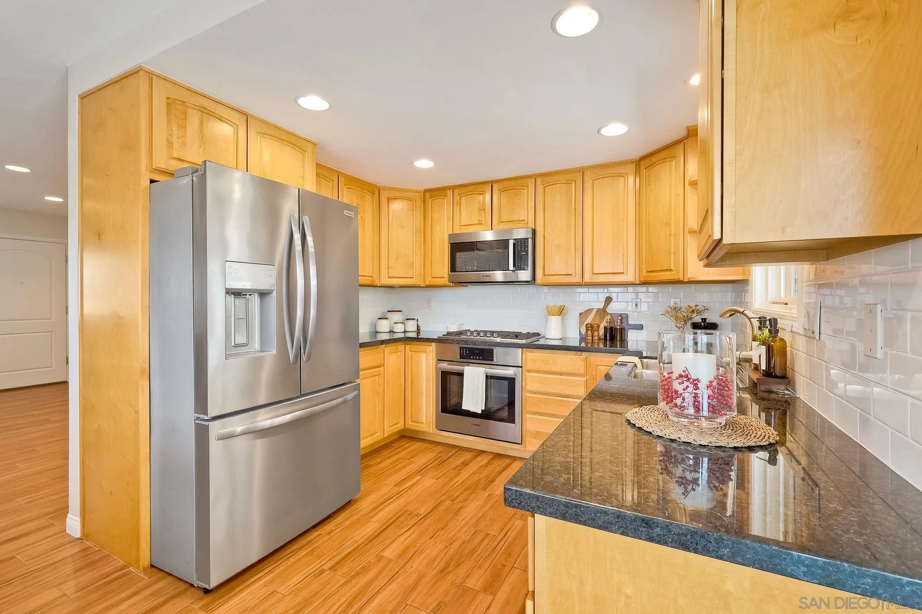 8850 Ellsworth Circle Santee, CA 92071 - Photo 11 of 29 a kitchen with kitchen island granite countertop wooden floors stainless steel appliances and cabinets