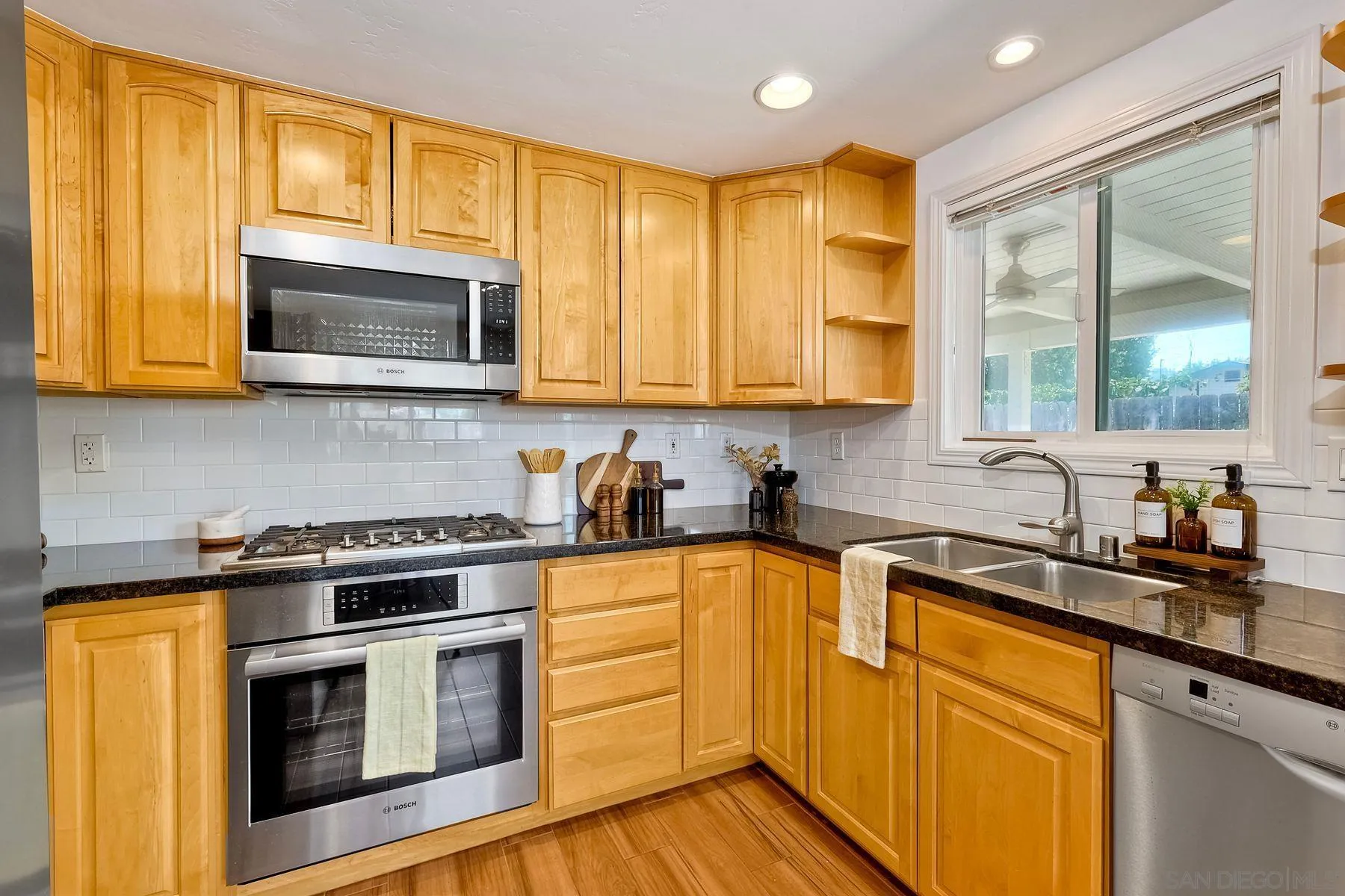 8850 Ellsworth Circle Santee, CA 92071 - Photo 13 of 29 a kitchen with stainless steel appliances granite countertop a stove sink microwave and cabinets