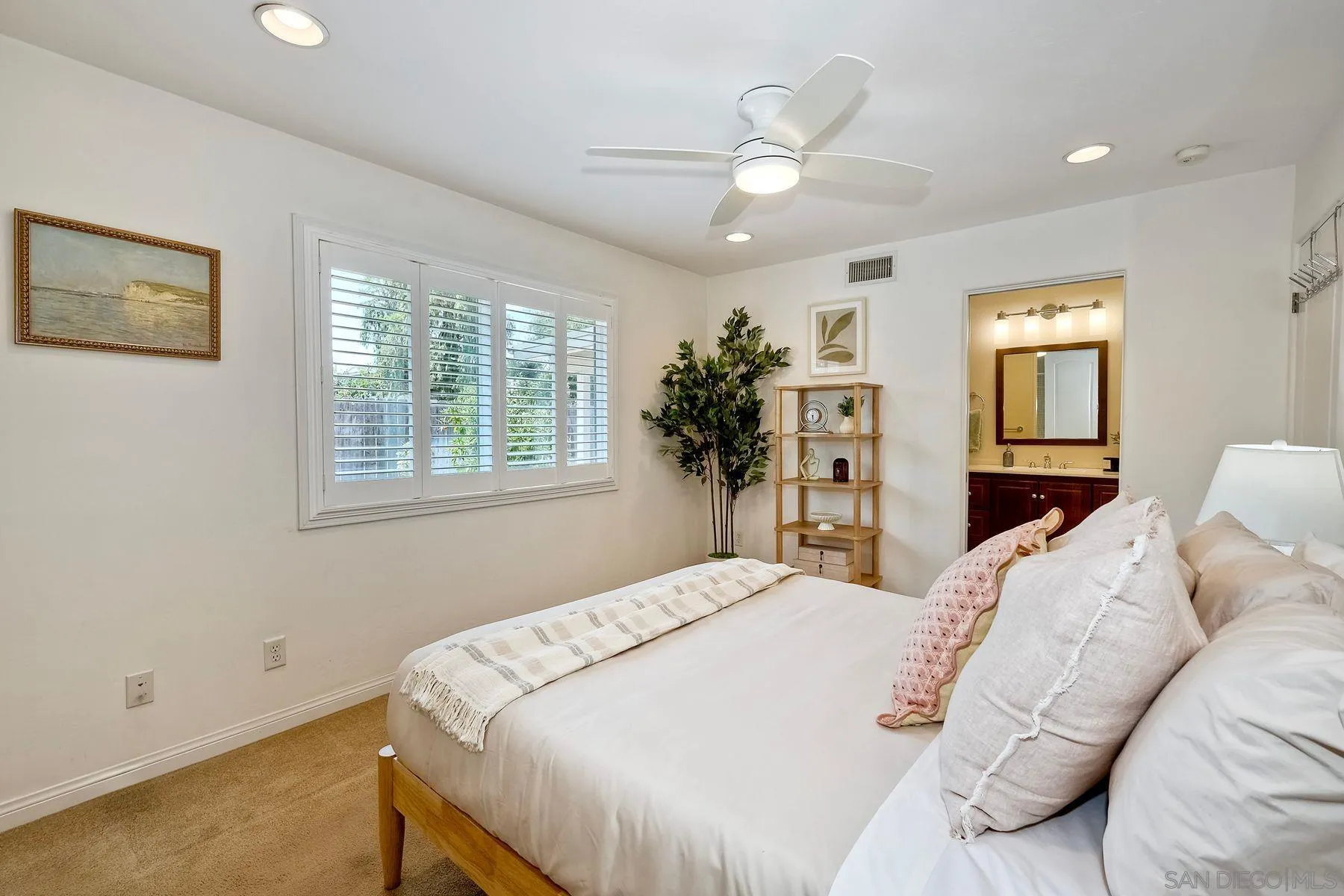 8850 Ellsworth Circle Santee, CA 92071 - Photo 18 of 29 a bedroom with a large bed and a chandelier