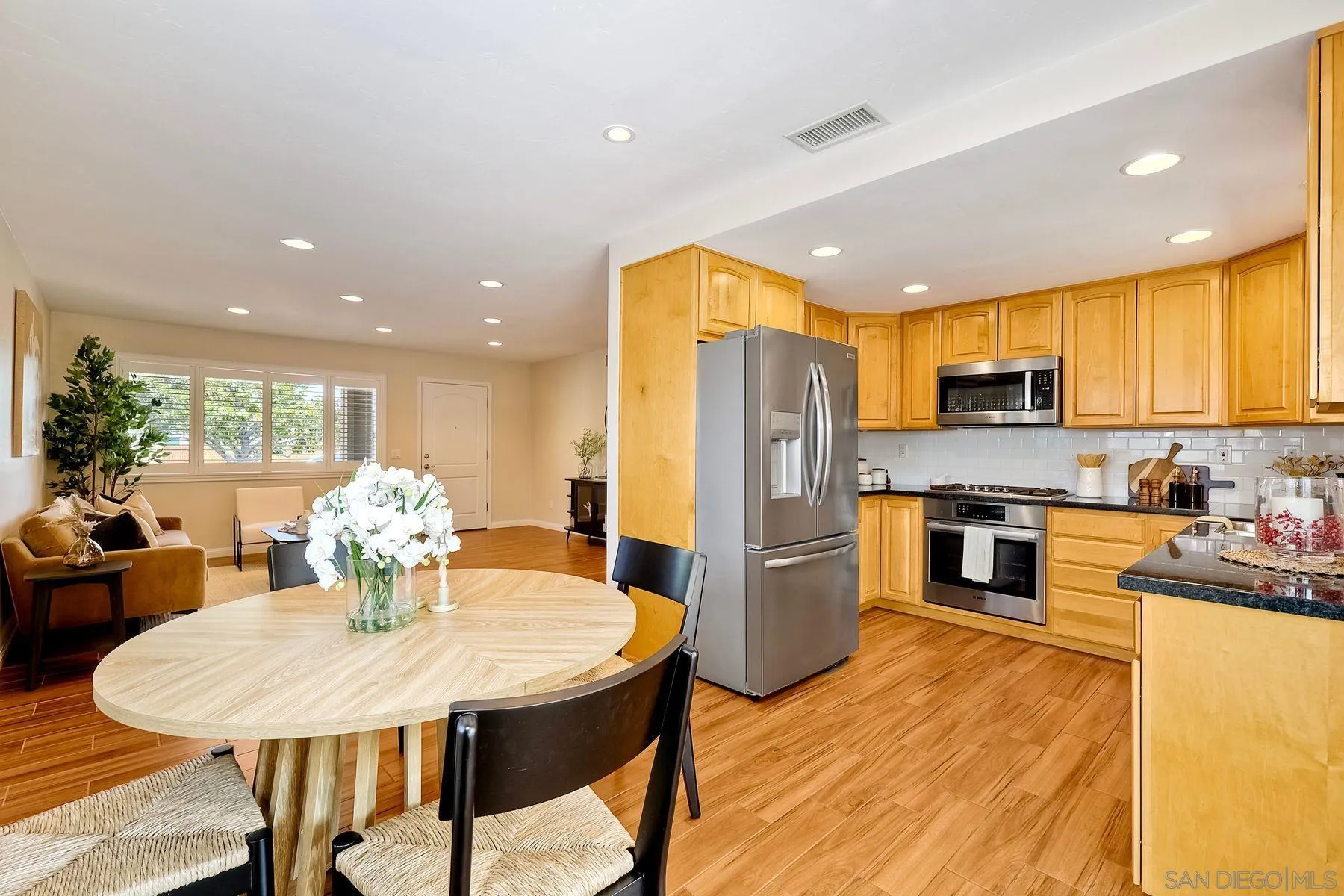 8850 Ellsworth Circle Santee, CA 92071 - Photo 10 of 29 a kitchen with stainless steel appliances kitchen island granite countertop a kitchen island hardwood floor and a stove top oven