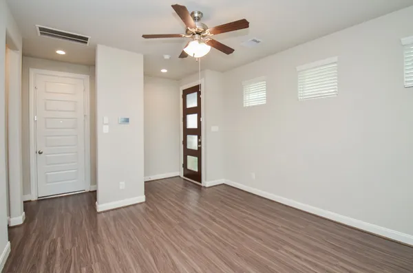 wooden floor in an empty room with a window