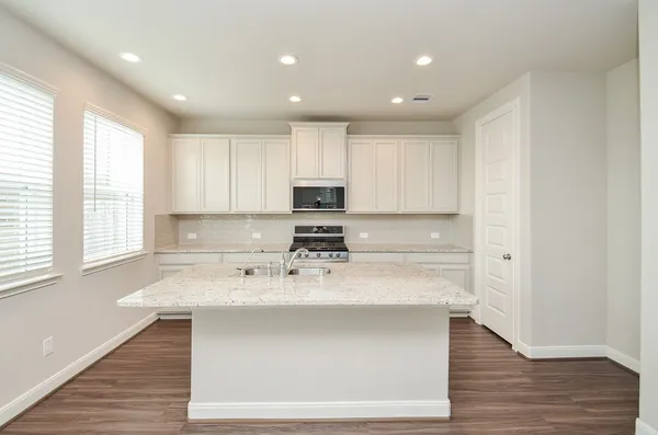 a kitchen with a sink stainless steel appliances and cabinets