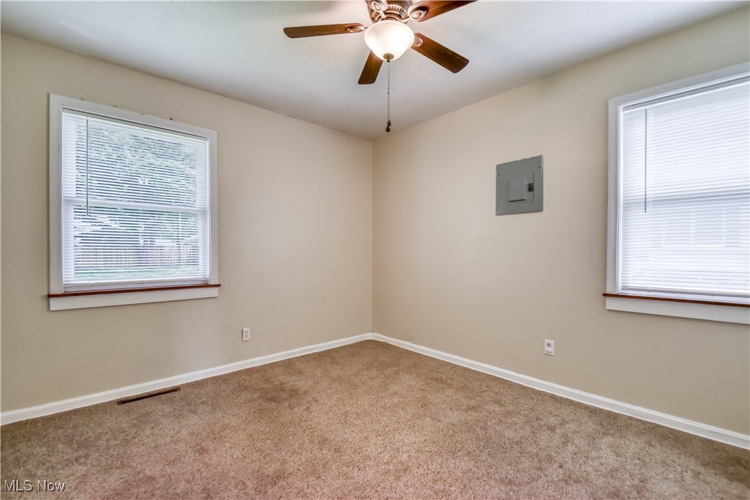 1919 Sandgate Road Madison, OH 44057 - Photo 15 of 28 Spare room with carpet floors, electric panel, and ceiling fan