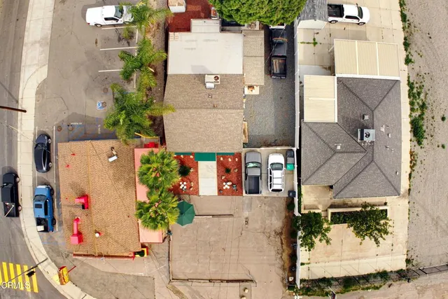 an aerial view of residential houses with outdoor space and street view