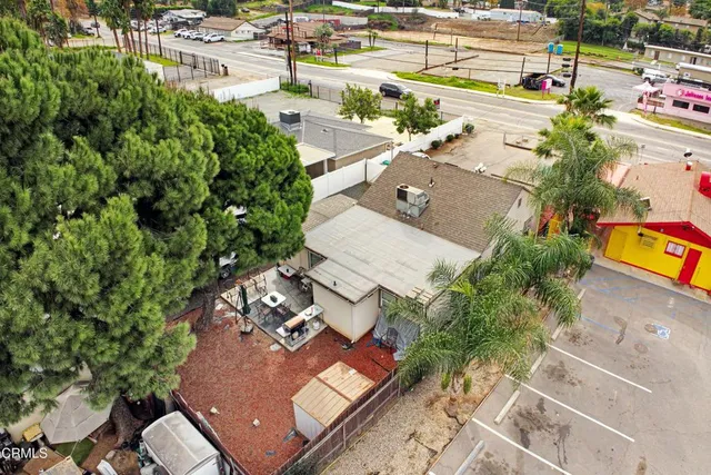 an aerial view of a house with a yard and lake view