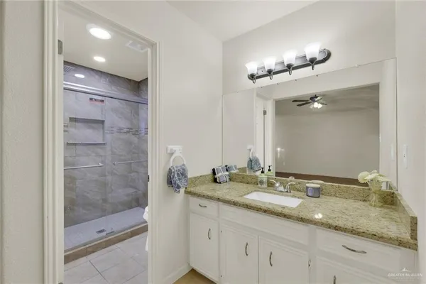 a bathroom with double sink and a mirror
