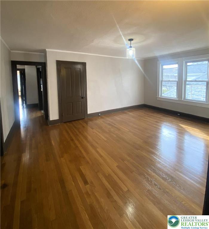 436 Wheeler Avenue, Unit 3 Scranton, PA 18510 - Photo 3 of 8 an empty room with wooden floor and windows