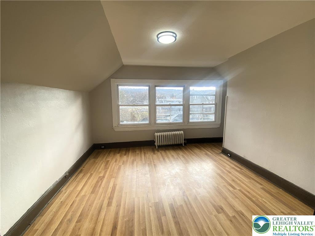 436 Wheeler Avenue, Unit 3 Scranton, PA 18510 - Photo 6 of 8 an empty room with wooden floor and windows