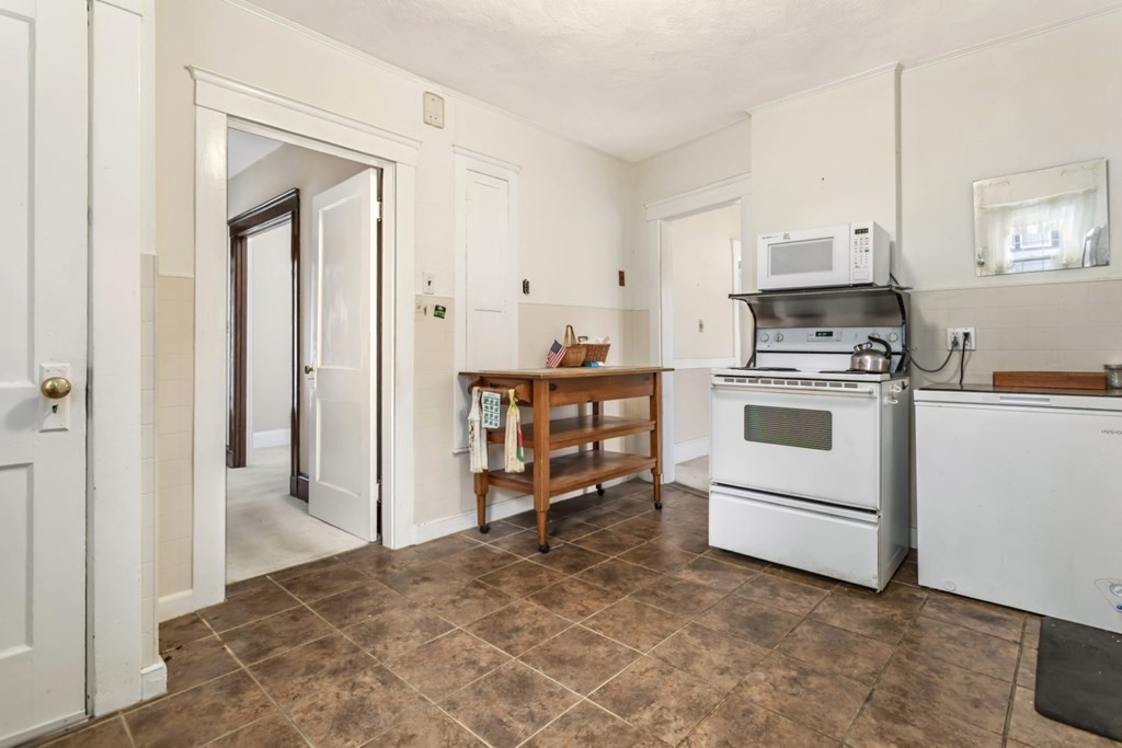 78 Ashcroft Road Medford, MA 02155 - Photo 11 of 34 a kitchen with a stove and white cabinets