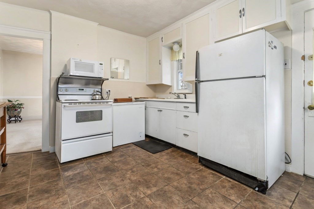 78 Ashcroft Road Medford, MA 02155 - Photo 12 of 34 a kitchen with cabinets a refrigerator and a sink