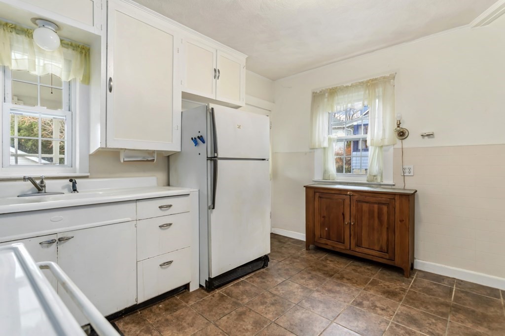 78 Ashcroft Road Medford, MA 02155 - Photo 13 of 34 a kitchen with cabinets a refrigerator and a sink