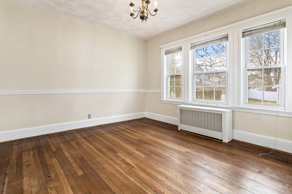 78 Ashcroft Road Medford, MA 02155 - Photo 14 of 34 an empty room with wooden floor and windows