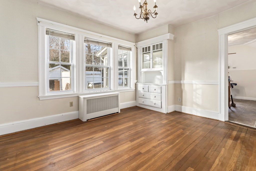 78 Ashcroft Road Medford, MA 02155 - Photo 15 of 34 a view of an empty room with a window and wooden floor