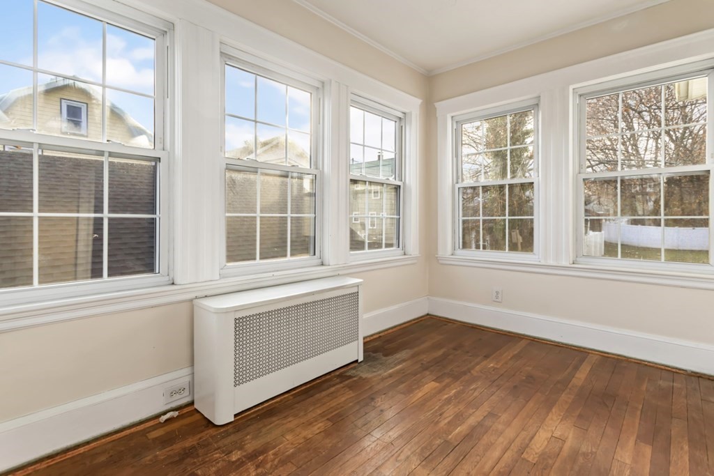 78 Ashcroft Road Medford, MA 02155 - Photo 17 of 34 an empty room with wooden floor and windows