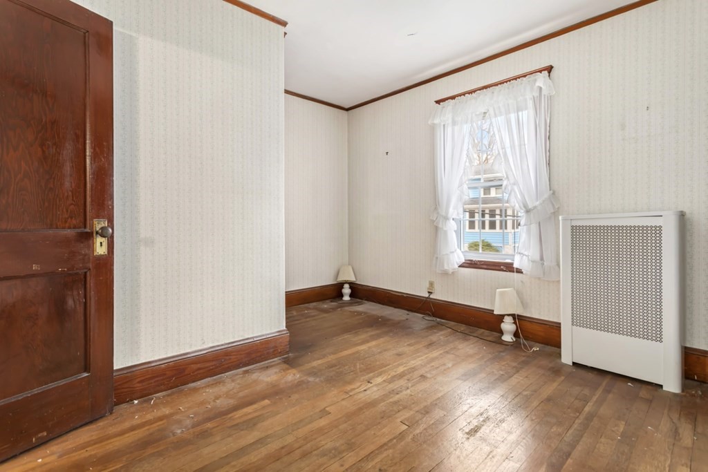 78 Ashcroft Road Medford, MA 02155 - Photo 21 of 34 an empty room with wooden floor and windows
