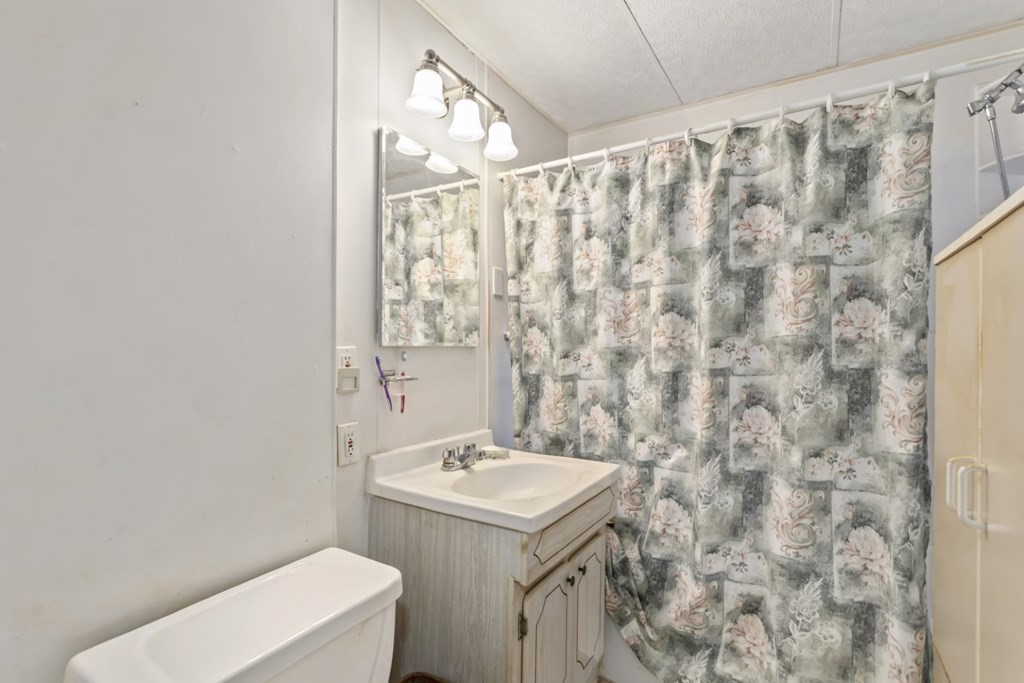 78 Ashcroft Road Medford, MA 02155 - Photo 25 of 34 a bathroom with a sink and mirror with toilet