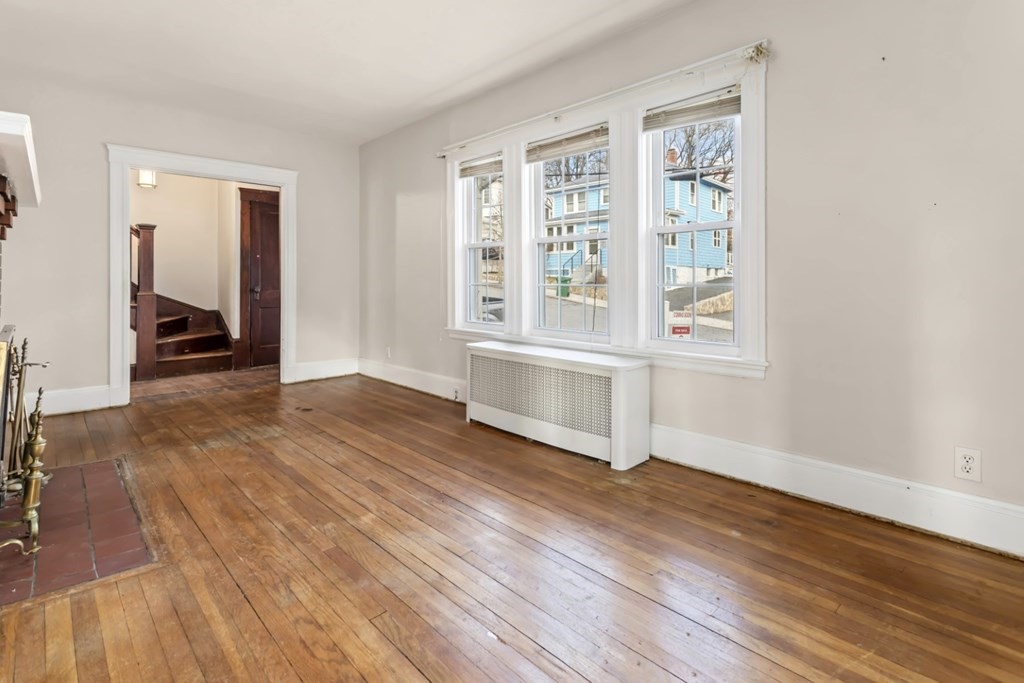78 Ashcroft Road Medford, MA 02155 - Photo 8 of 34 an empty room with wooden floor and windows