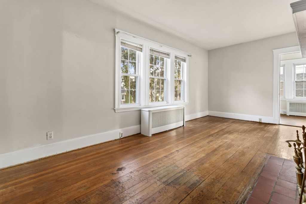 78 Ashcroft Road Medford, MA 02155 - Photo 9 of 34 an empty room with wooden floor and windows