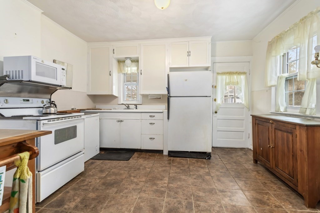 78 Ashcroft Road Medford, MA 02155 - Photo 10 of 34 a kitchen with white cabinets and white appliances