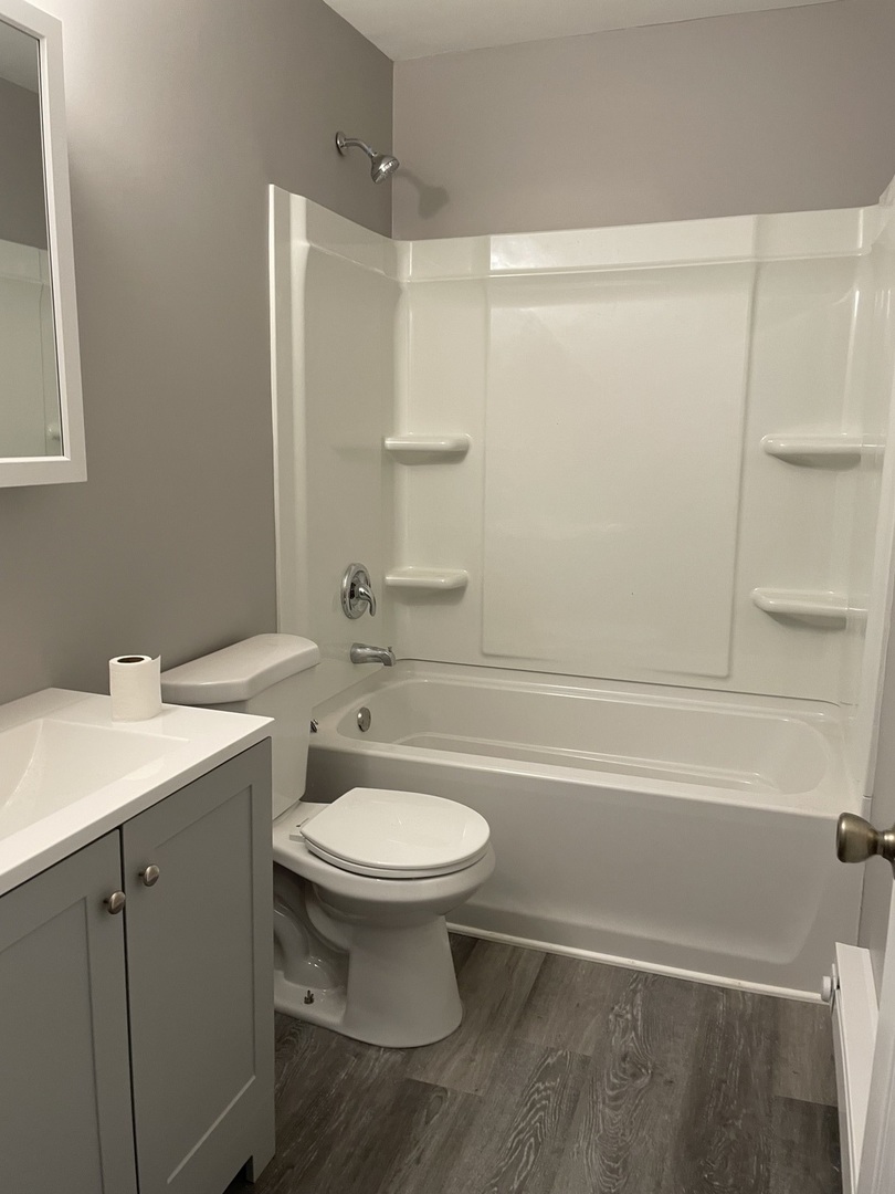 1389 Monomoy Street, Unit B2 Aurora, IL 60506 - Photo 6 of 6 a bathroom with a sink a toilet and shower