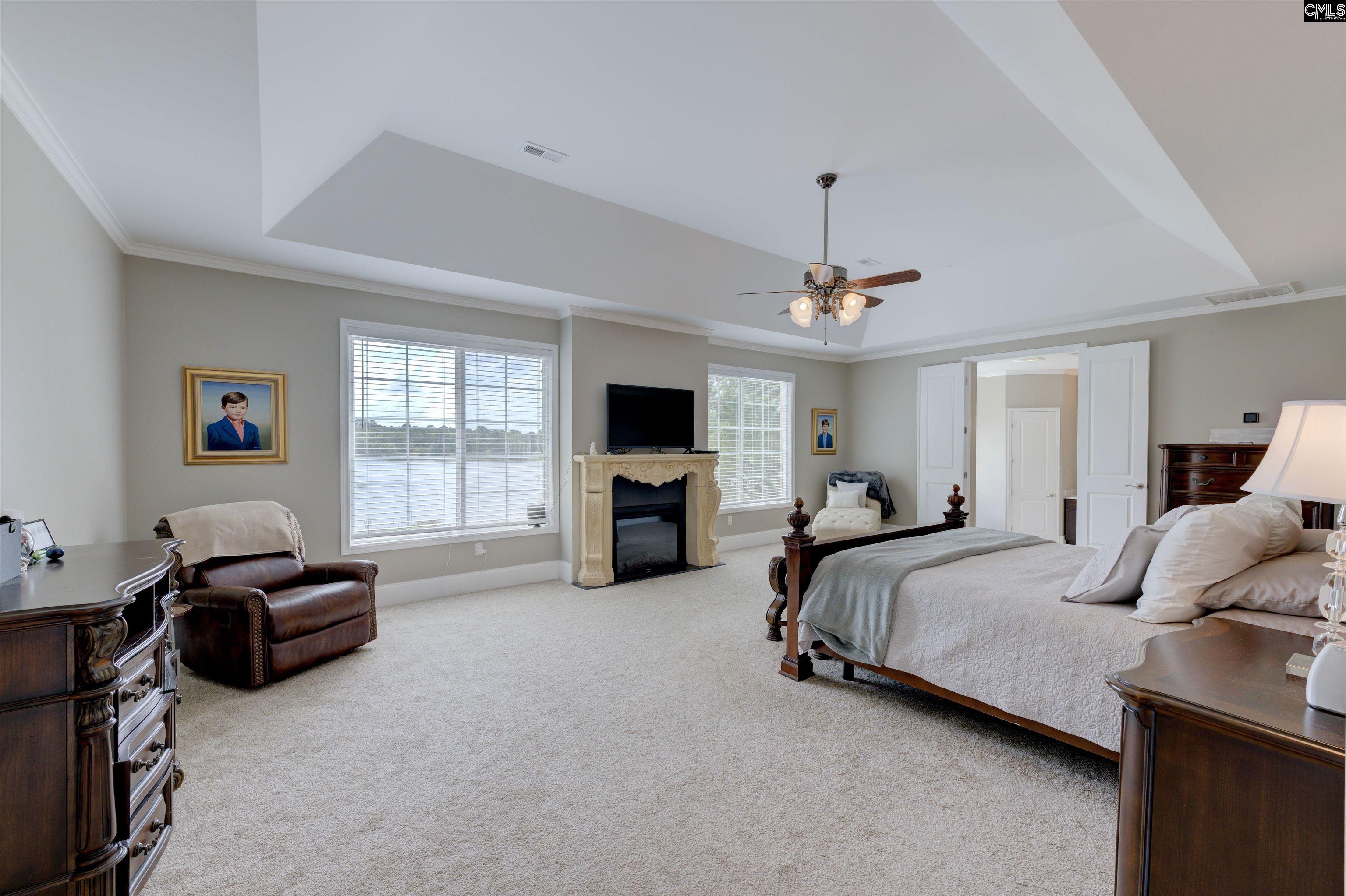 305 Northlake Road Columbia, SC 29223 - Photo 27 of 46 a spacious bedroom with a bed couch and a window
