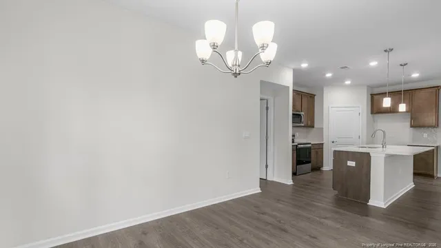 a view of a kitchen with a sink stainless steel appliances and cabinets