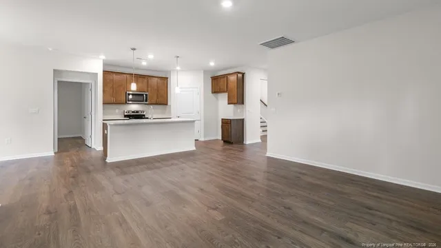 a view of kitchen with wooden floor and electronic appliances