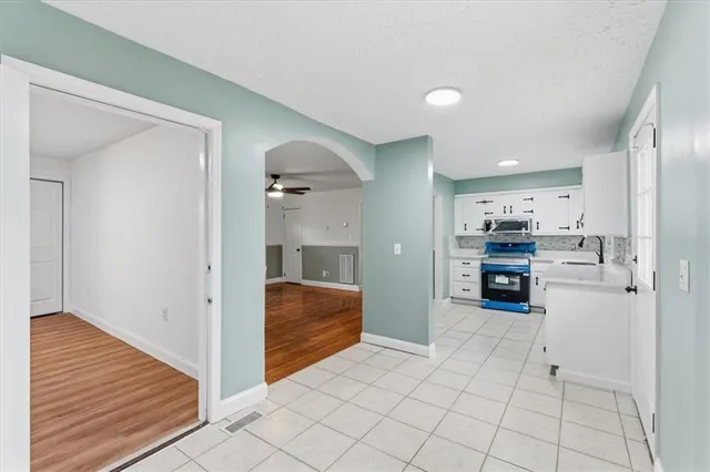 a view of kitchen with refrigerator and window
