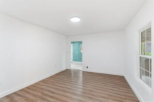 wooden floor in an empty room with a window