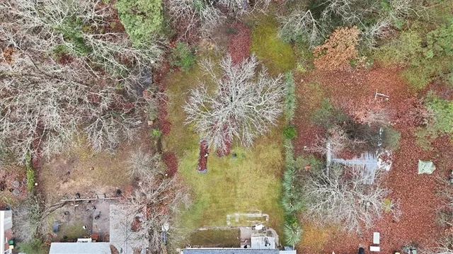 a aerial view of a residential houses with yard