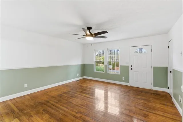 wooden floor in an empty room with a window