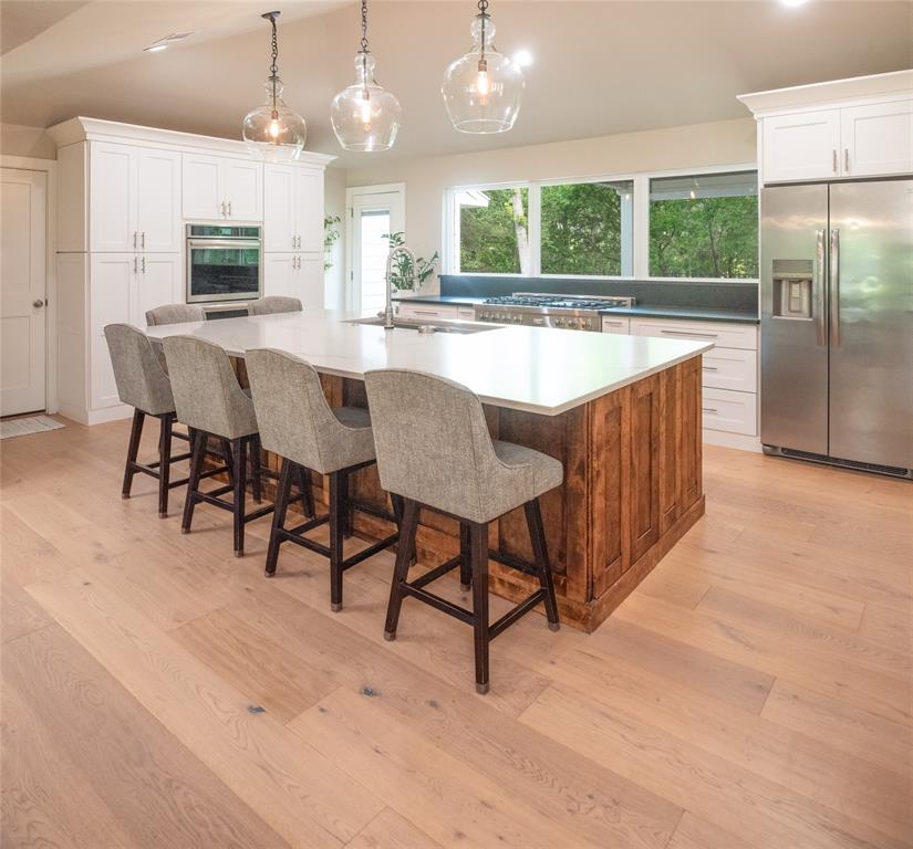 1451 Meandro Ria Lane Fairview, TX 75069 - Photo 8 of 38 a large kitchen with kitchen island a table and chairs