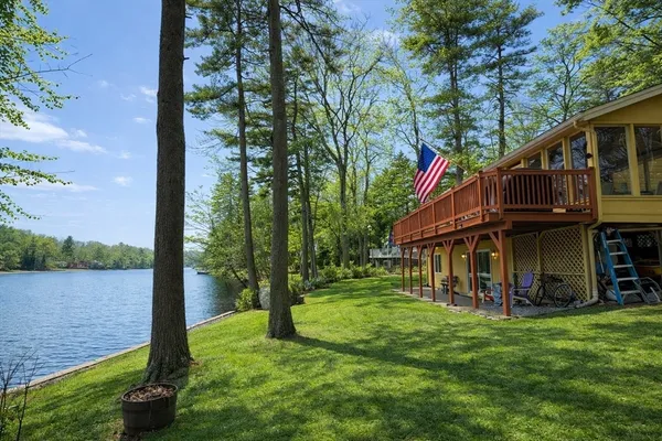 a view of a house with a yard and a tree
