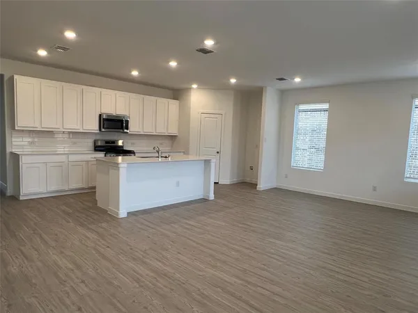 a view of a kitchen and a sink a window in a room