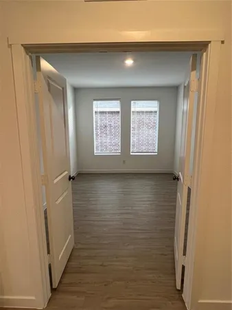 a view of a kitchen with a sink and wooden floor