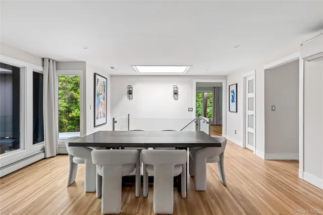 a kitchen with a sink and chairs