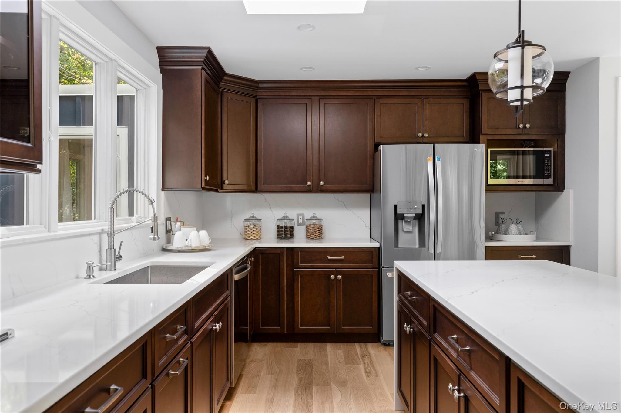 25 Wood Road Sands Point, NY 11050 - Photo 14 of 33 a kitchen with stainless steel appliances a sink cabinets and wooden floor