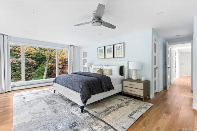 a bedroom with a large bed and a flat tv