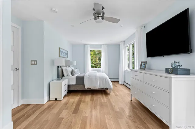 a spacious bedroom with a bed and a flat screen tv