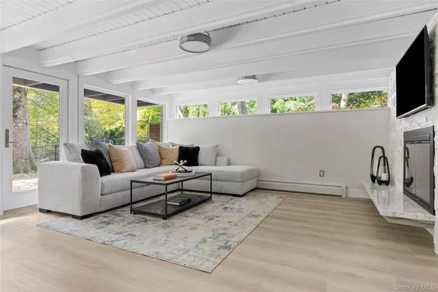a balcony with wooden floor and furniture