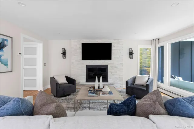 a living room with furniture a flat screen tv and a fireplace