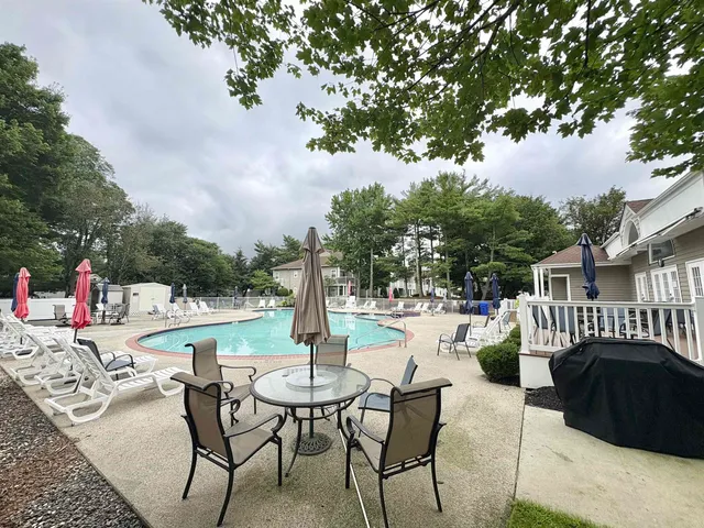 a view of a patio with a table and chairs